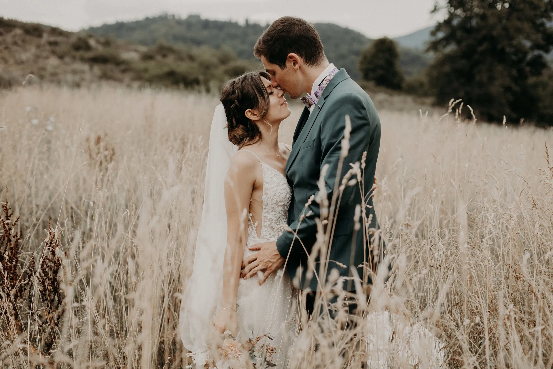 Couple de mariés dans les hautes herbes, mariage en Alsace